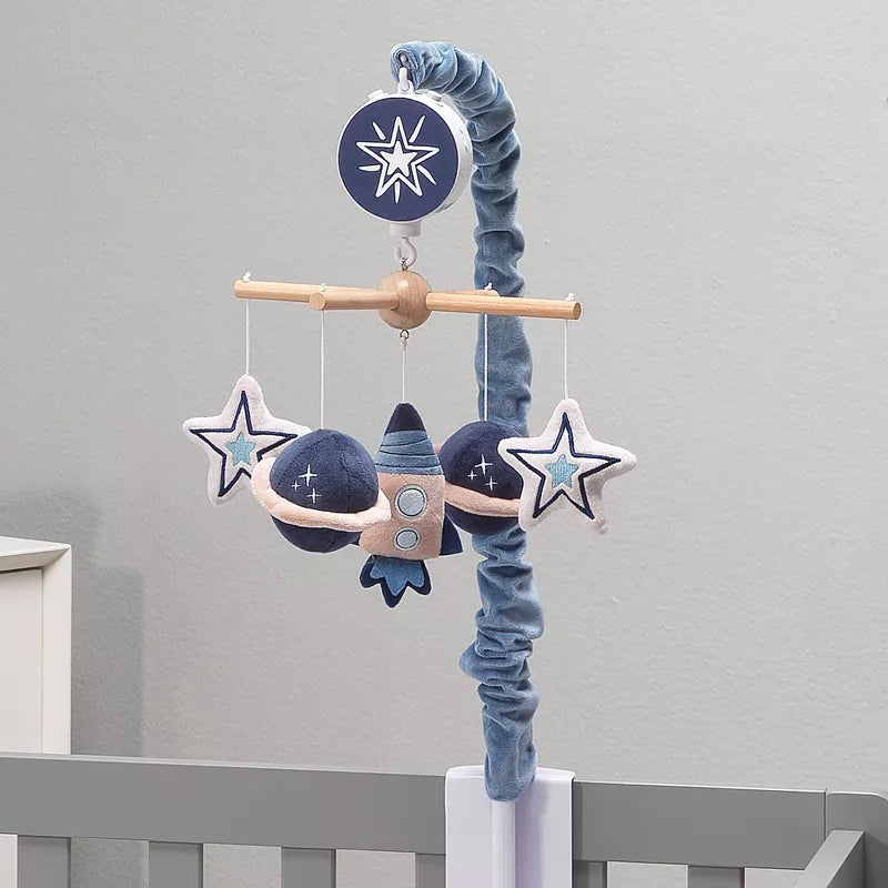 Musical baby crib mobile with hanging rocket, planets, and stars above a crib