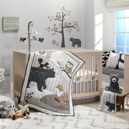 A cozy woodland-themed nursery with a crib, bedding, mobile, plush animals, and wall decals
