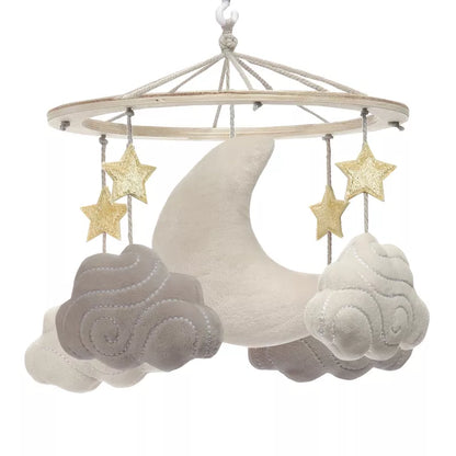 A baby crib mobile featuring a moon, stars, and clouds hanging from a wooden ring