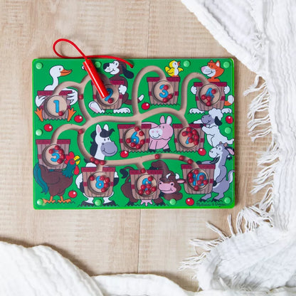 A magnetic wand number maze toy featuring farm animals, numbered baskets, and a red magnetic wand