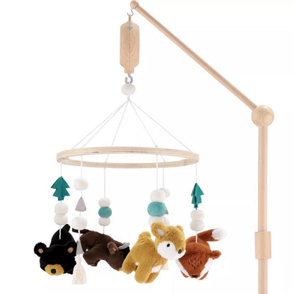 A wooden baby crib mobile with hanging woodland animals