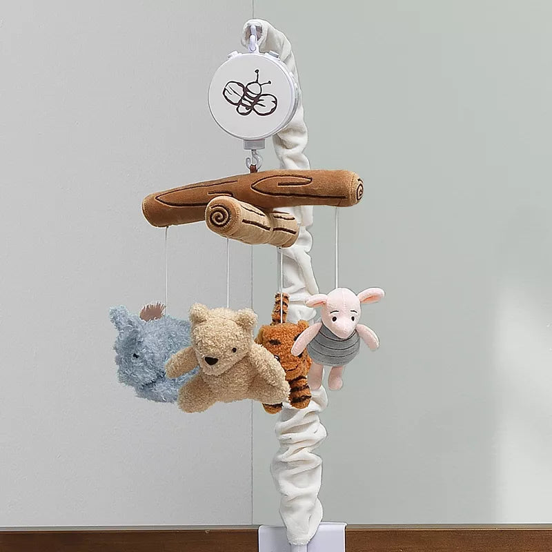 A baby crib mobile hangs, featuring plush characters