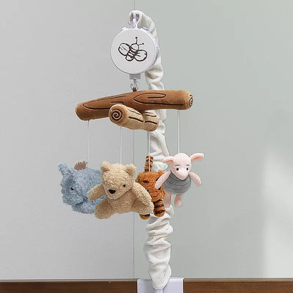 A baby crib mobile hangs, featuring plush characters