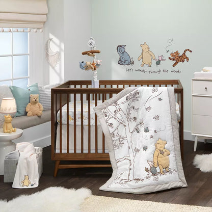 A Winnie the Pooh themed baby nursery with a crib, bedding, mobile, and wall decals