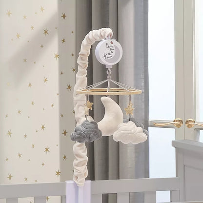 A baby crib mobile featuring a moon, stars, and clouds, attached to a crib