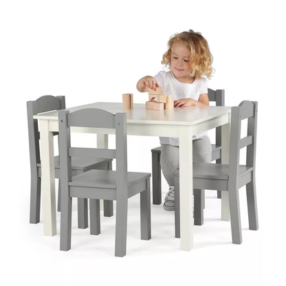 A child playing with blocks at a small white and grey table with four matching chairs