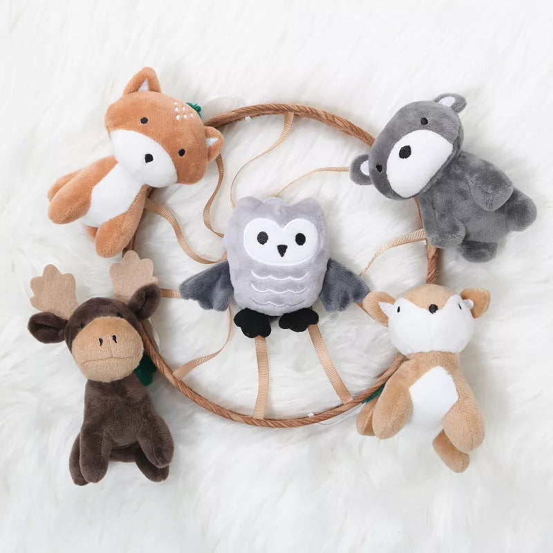 A baby mobile with five stuffed woodland animals (fox, wolf, owl, moose, deer) hanging from a circular frame.