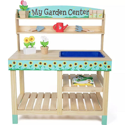 A wooden toy gardening center playset with shelves, a sink, tools, and potted flowers