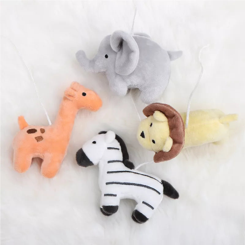 An overhead view of four plush safari animals: an elephant, giraffe, zebra, and lion