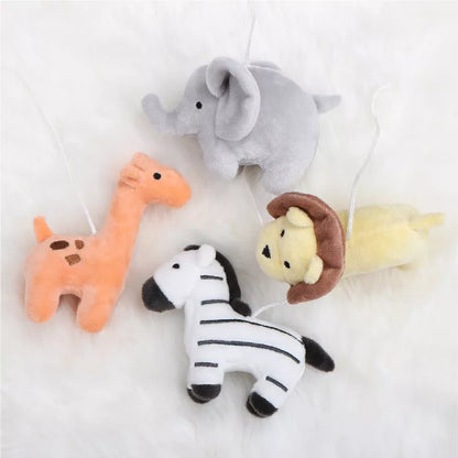 An overhead view of four plush safari animals: an elephant, giraffe, zebra, and lion
