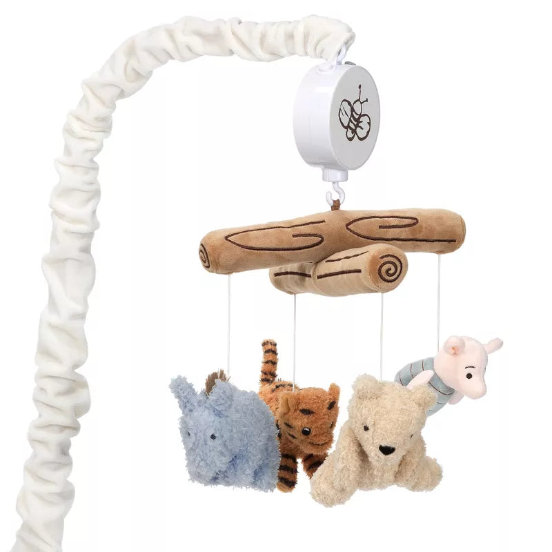 A baby crib mobile with plush animal characters and tree-like branches suspended from it