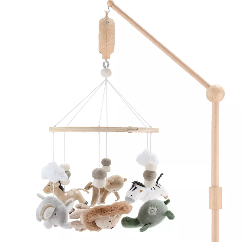A wooden baby crib mobile featuring hanging plush safari animals like an elephant, giraffe, zebra, and turtle