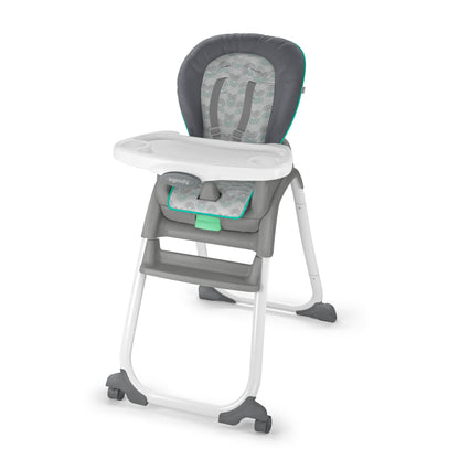 Gray and white high chair with green accents on a white background