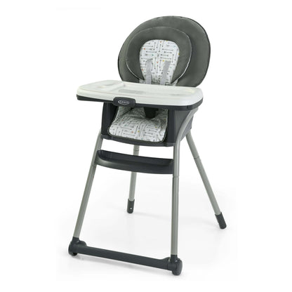 Gray and white high chair with patterned seat on a white background