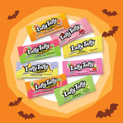 Halloween Candy, Assorted candy bars on an orange background with Halloween decorations.