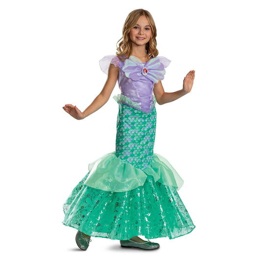 Halloween Child wearing a green and purple mermaid costume on a white background
