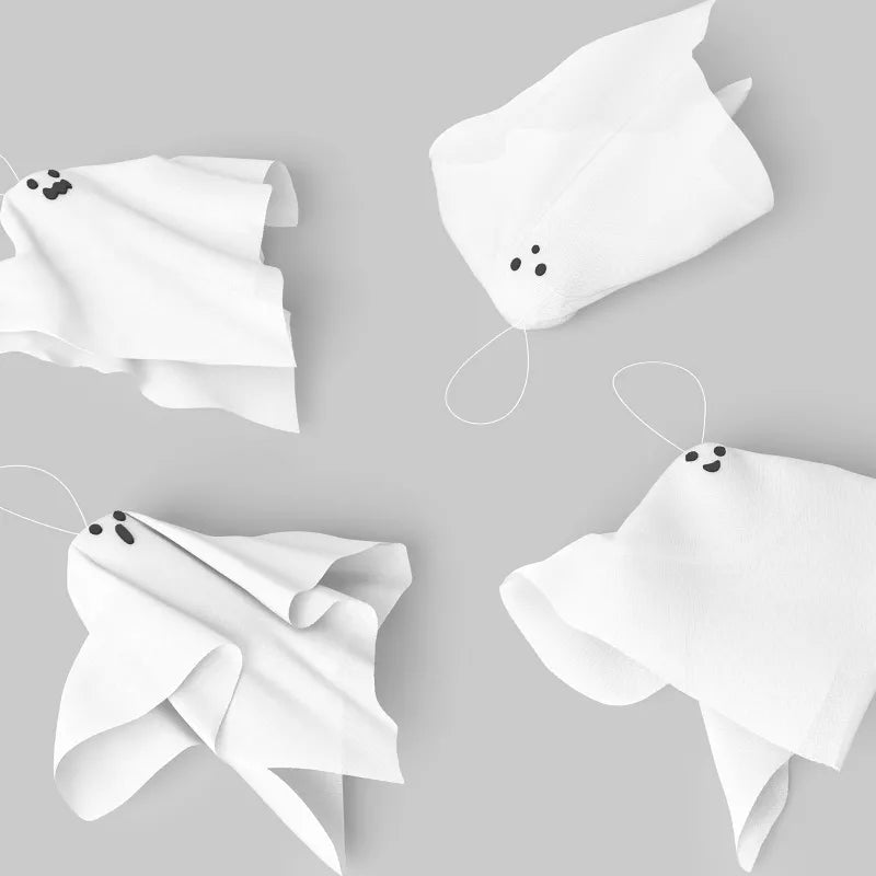 Halloween Decore White paper ghosts on a gray background