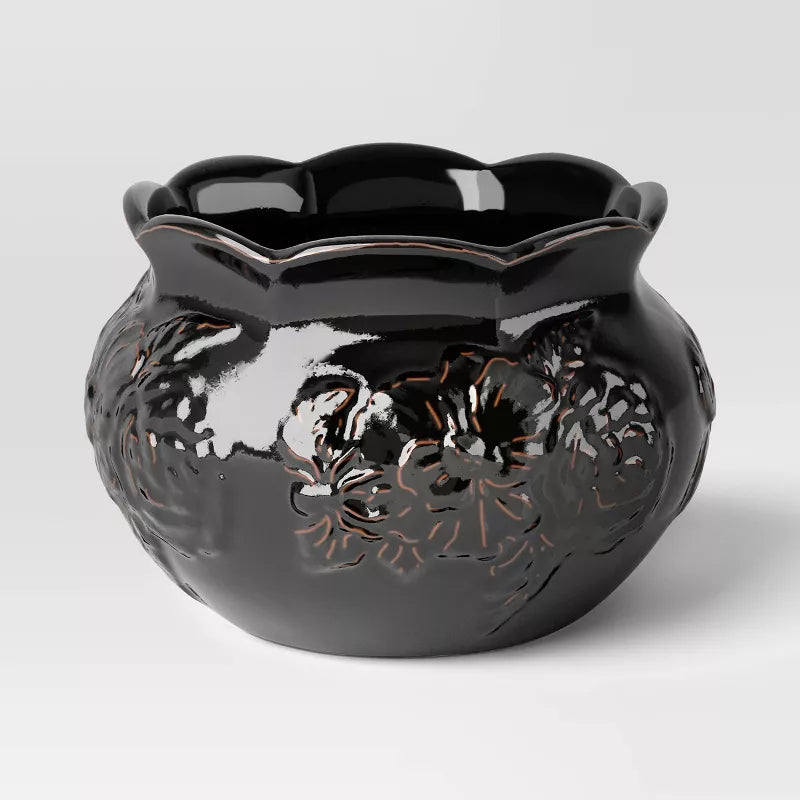 Halloween Themed Black ceramic vase with floral cutout design on a white background