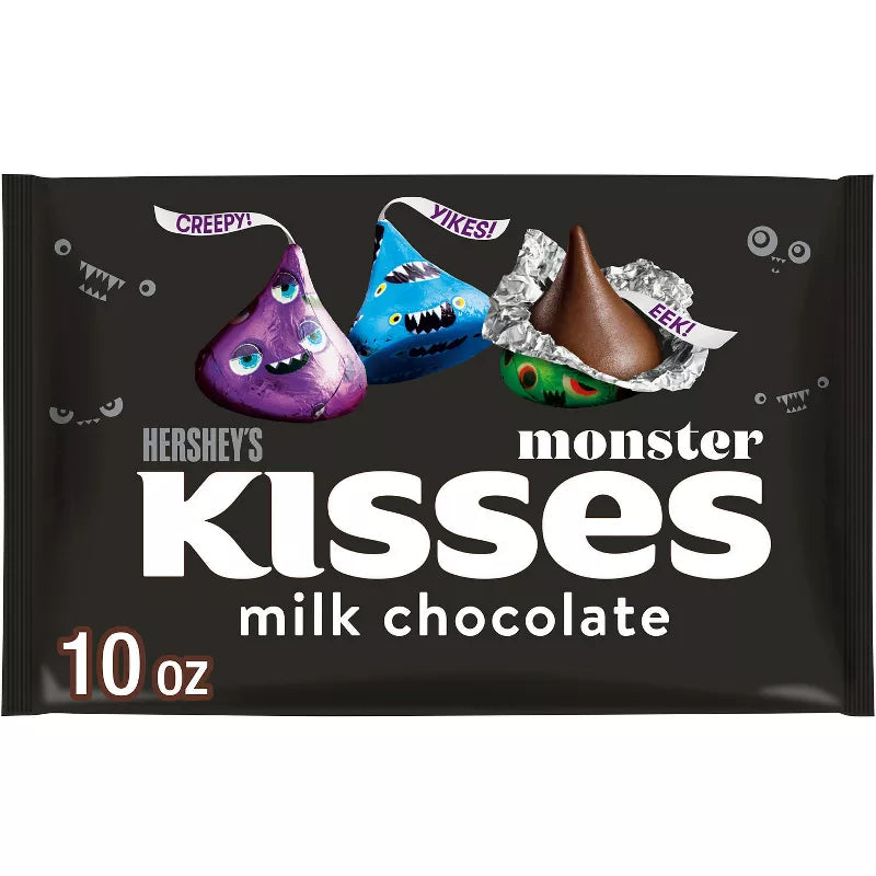 Halloween Themed Candy, Monster Kisses milk chocolate package with three colorful kisses on a black background.