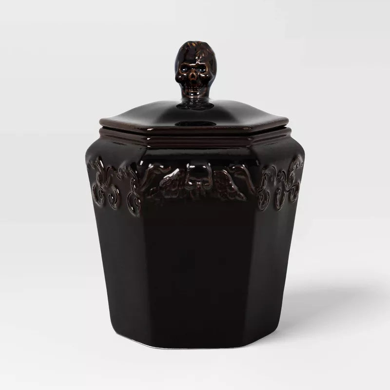 Halloween themed Black decorative jar with skull lid on a white background