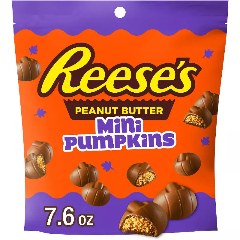 Halloween themed candy, Peanut Butter Mini Pumpkins packaging on an orange and purple background