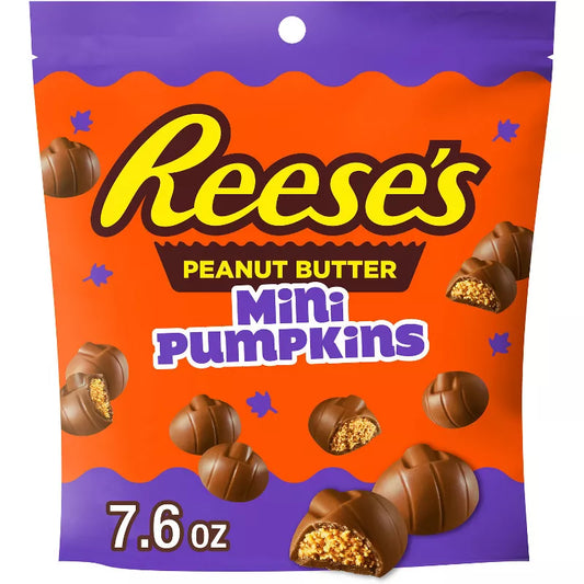 Halloween themed candy, Peanut Butter Mini Pumpkins packaging on an orange and purple background