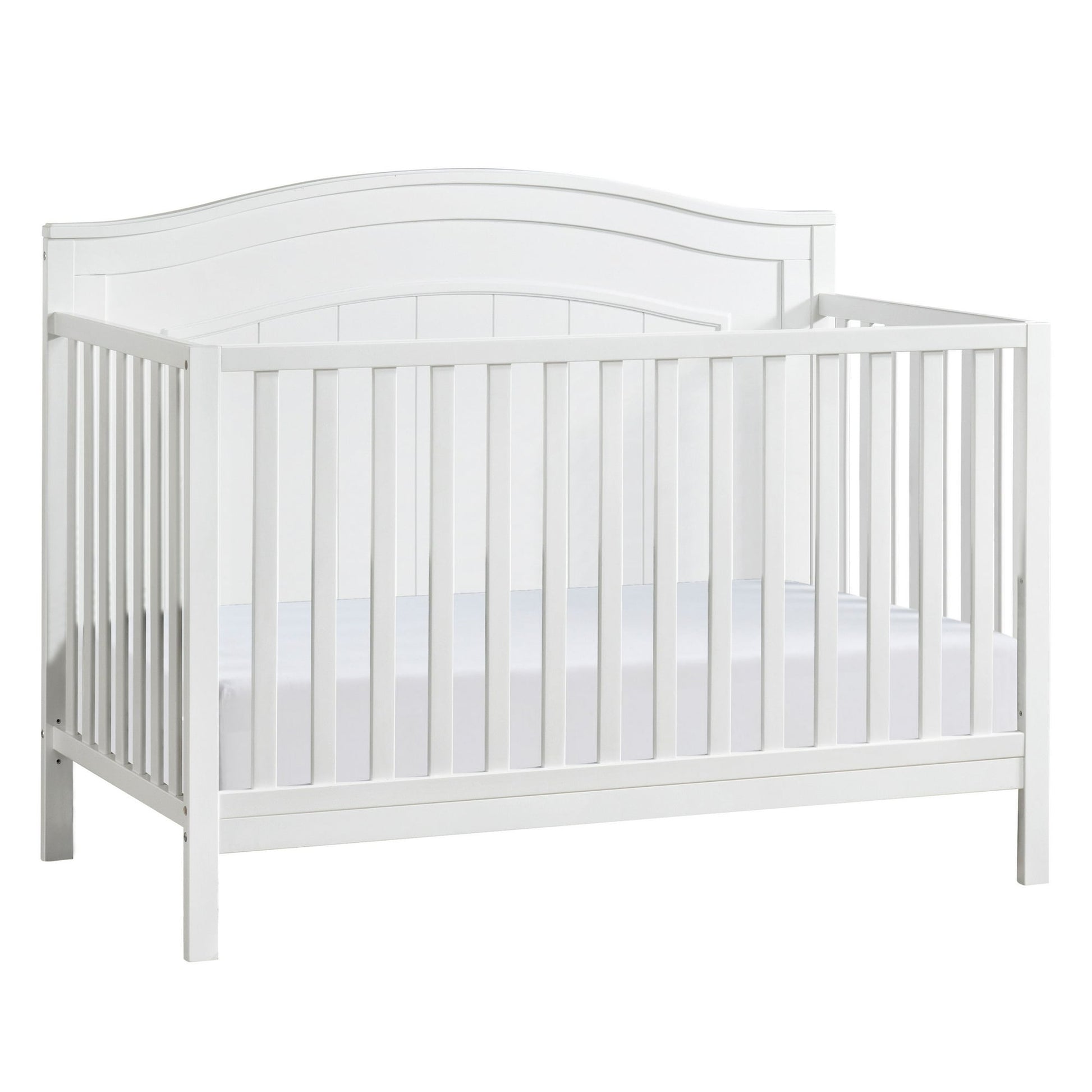 A white wooden baby crib with slatted sides and a curved headboard, containing a white mattress