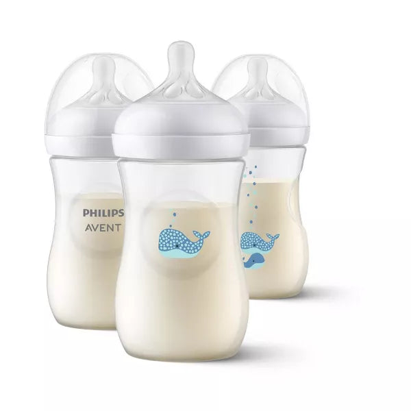 Three baby bottles with milk inside on a white background