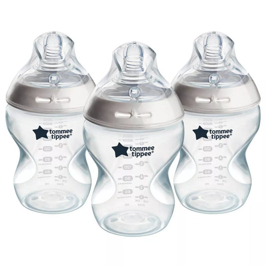 Three baby bottles with clear bottles and silver caps on a white background.