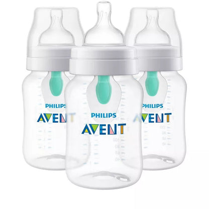 Three baby bottles with white caps on a white background
