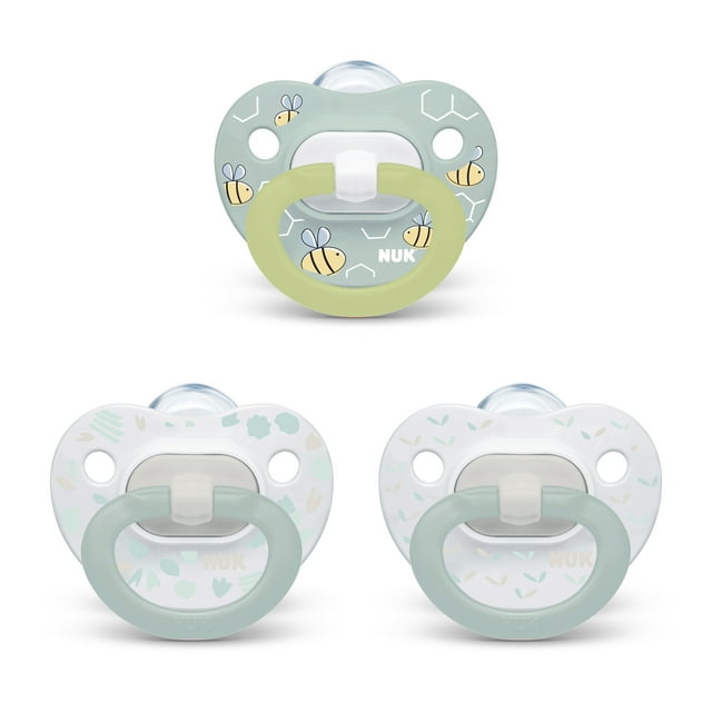 Three baby pacifiers with a light green and white design on a white background