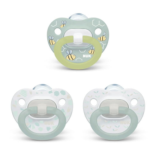 Three baby pacifiers with a light green and white design on a white background