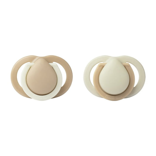 Two beige and white pacifiers on a white background