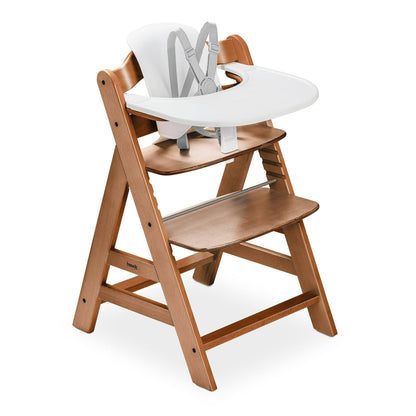 Wooden high chair with white tray and harness on a white background