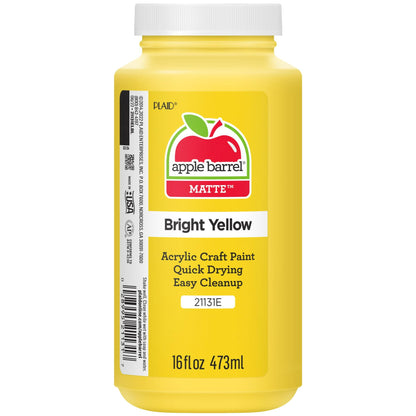 Yellow bottle of acrylic craft paint on a white background