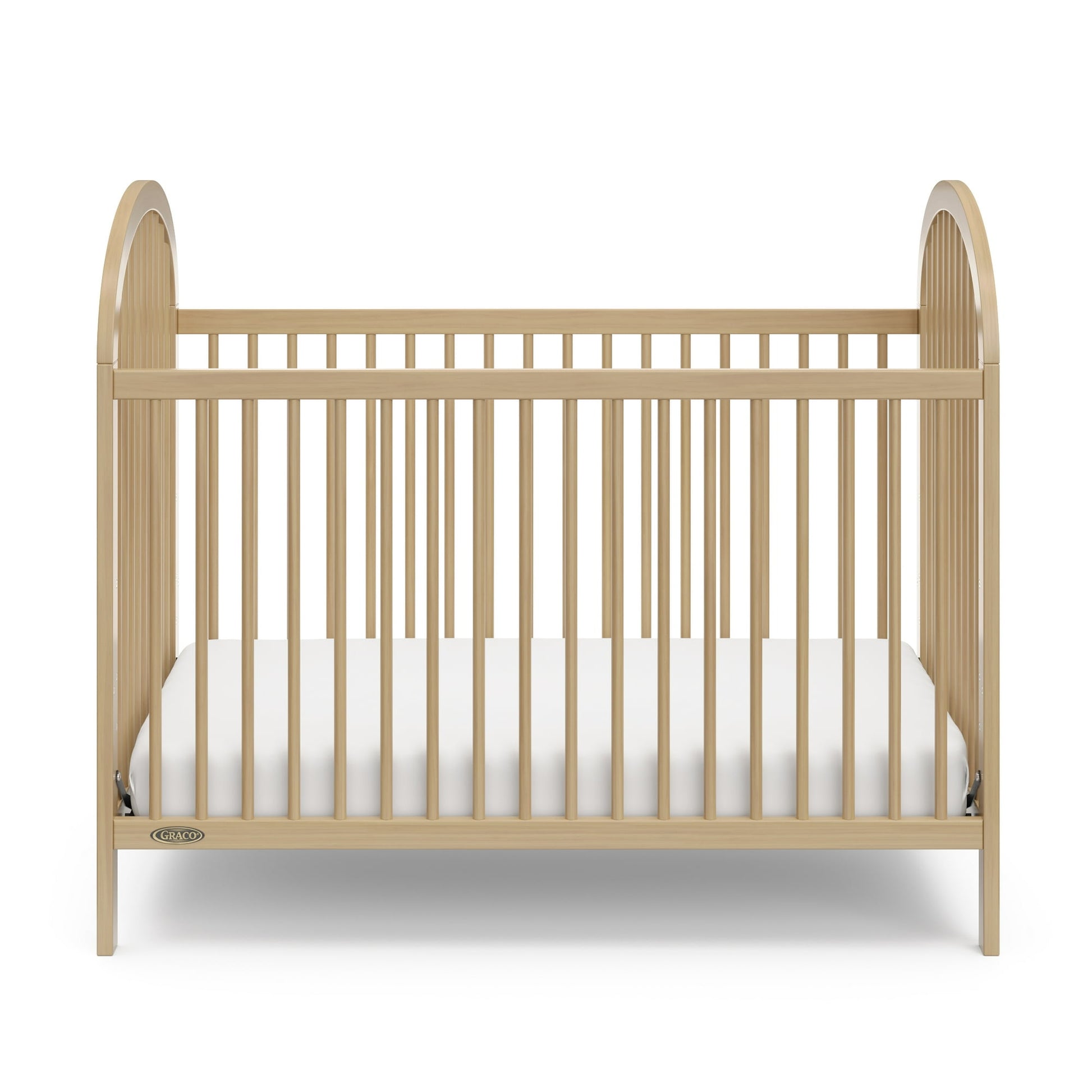 A wooden baby crib with a white mattress, designed for infants and toddlers