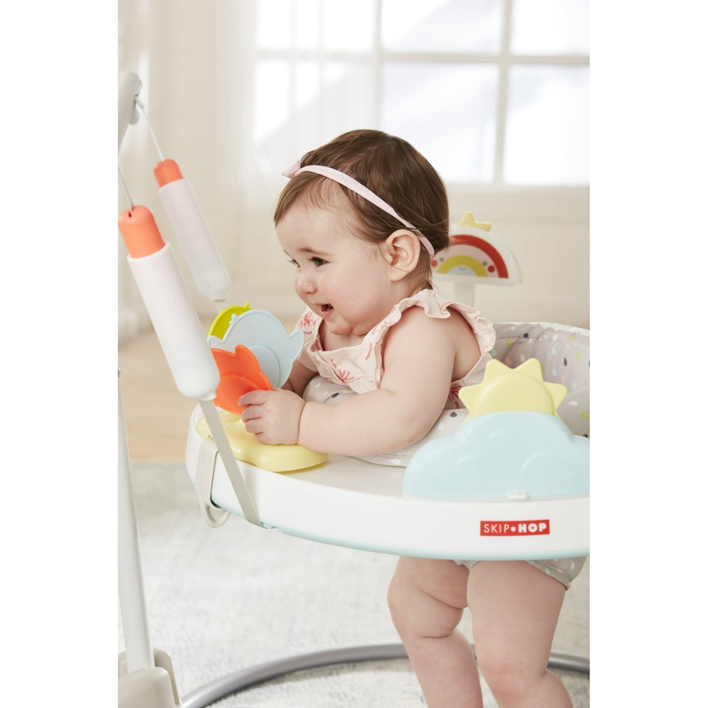 Image displaying a baby in a baby activity jumper