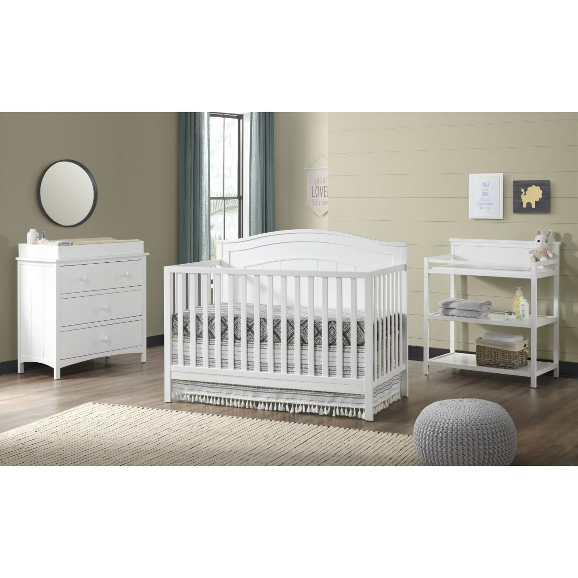 White nursery furniture set featuring a convertible crib, dresser with changing topper, and changing table