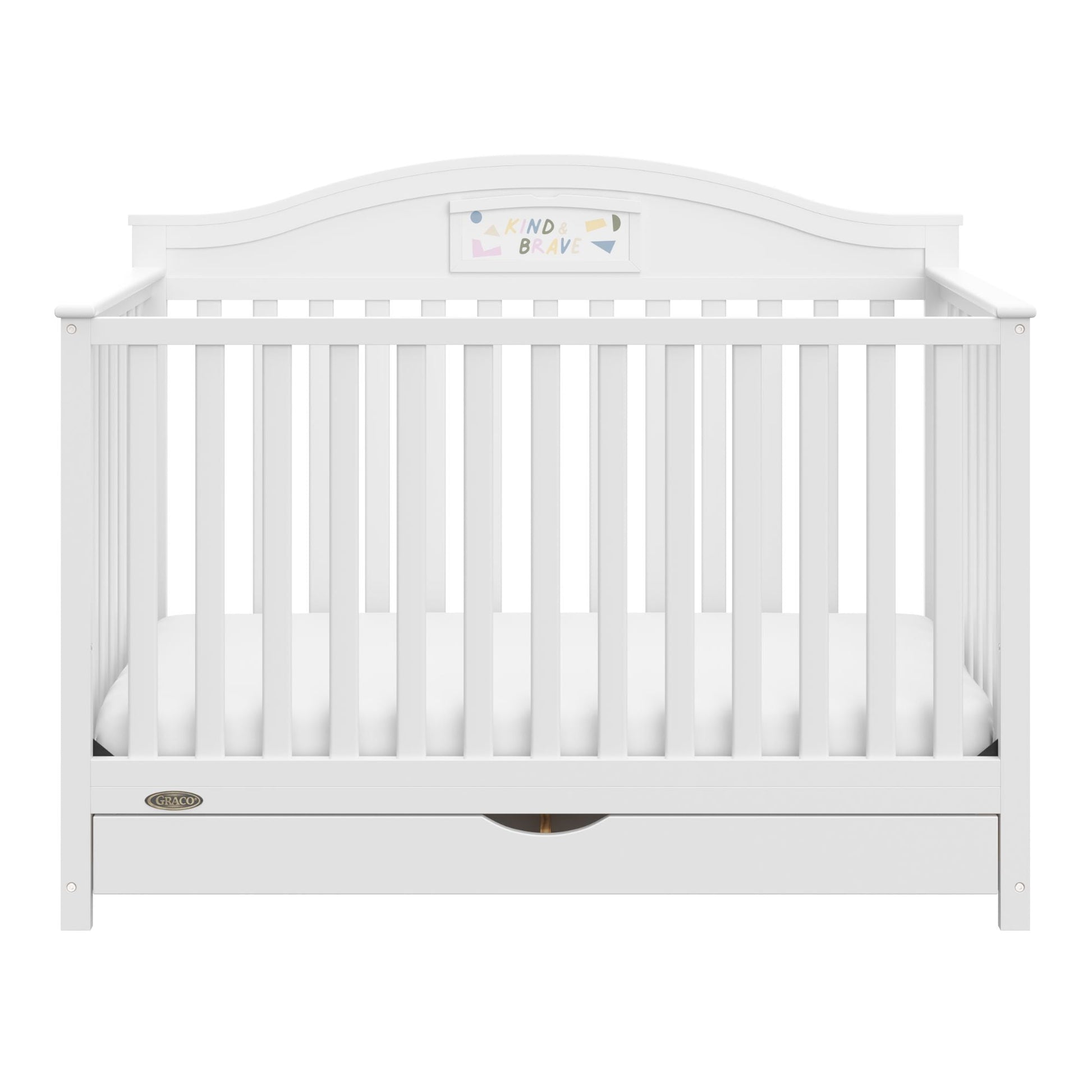 A white baby crib with vertical slats, a curved headboard, and a storage drawer underneath
