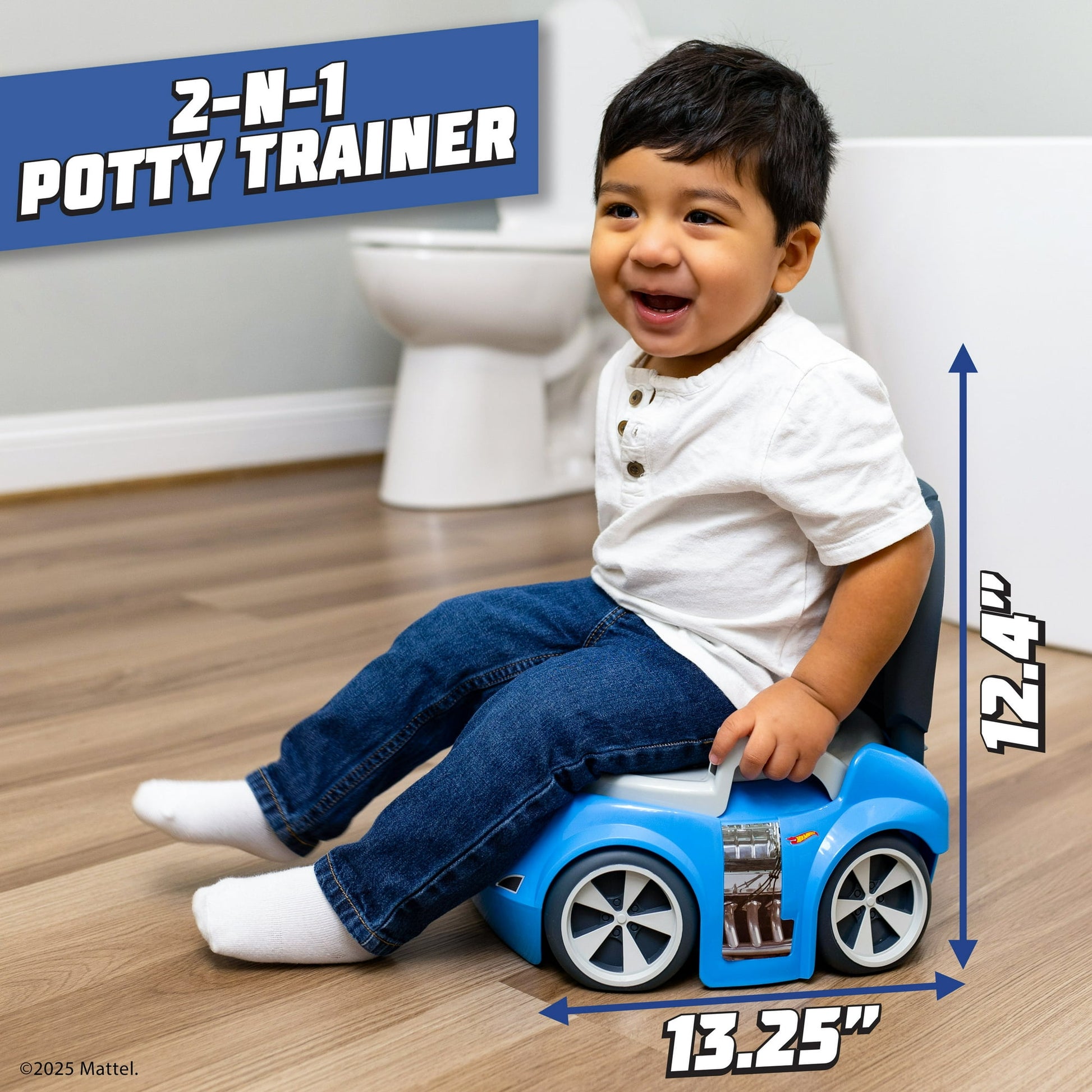 A smiling toddler sits on a blue car-shaped potty trainer, with a toilet in the background