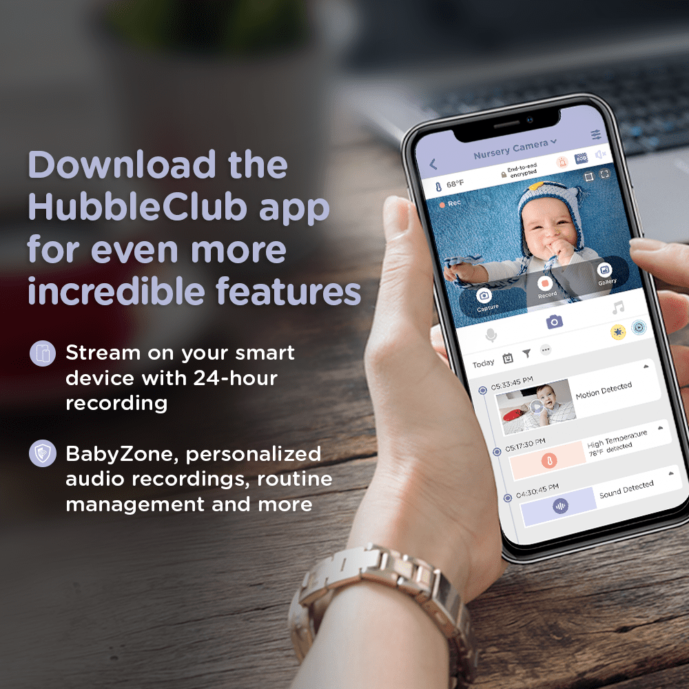 A hand holds a smartphone displaying a baby monitor app interface and its features