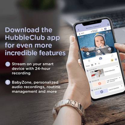 A hand holds a smartphone displaying a baby monitor app interface and its features