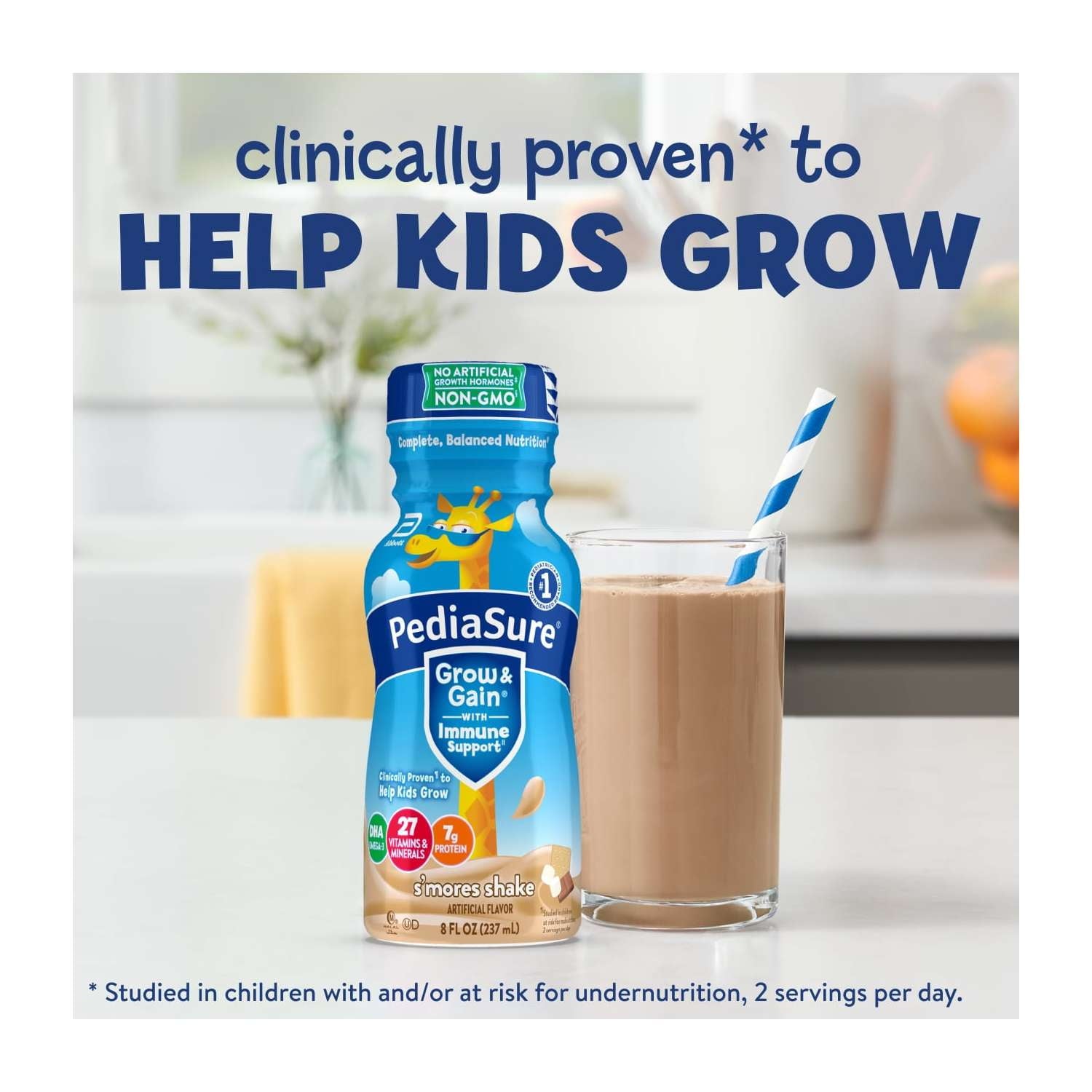 A bottle and a glass of nutritional shake with a straw on a counter, with blue text