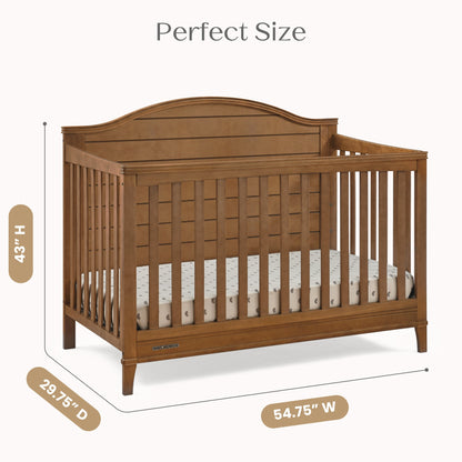 A wooden baby crib with mattress, displaying its height, depth, and width dimensions