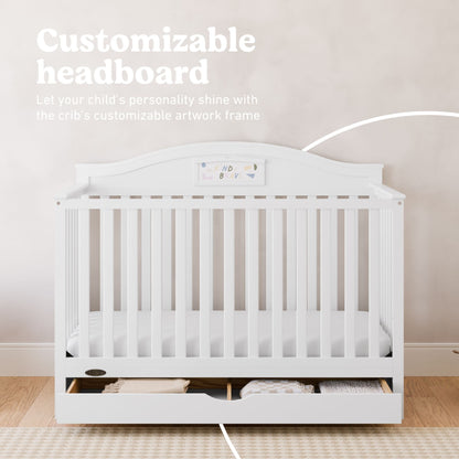 White baby crib with a customizable headboard and storage drawer underneath