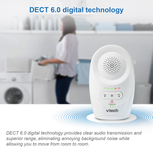 A white audio baby monitor unit in the foreground with a person doing laundry in the background